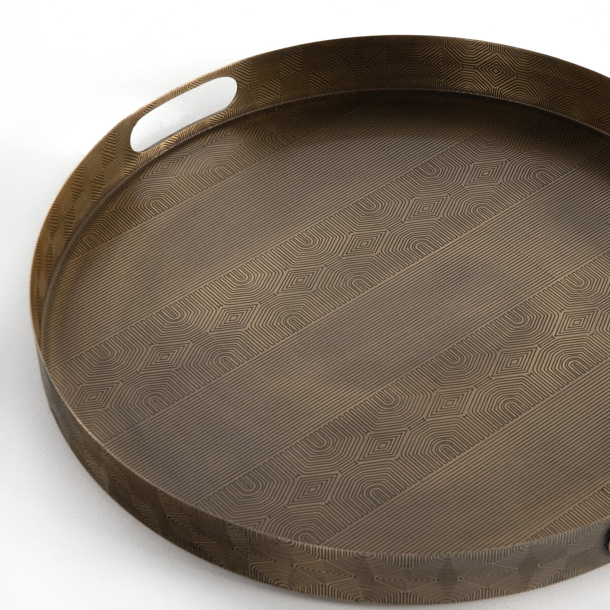Etched Brass Round Tray, a 20-inch round metal tray with integrated handles and an etched geometric line pattern across the surface.