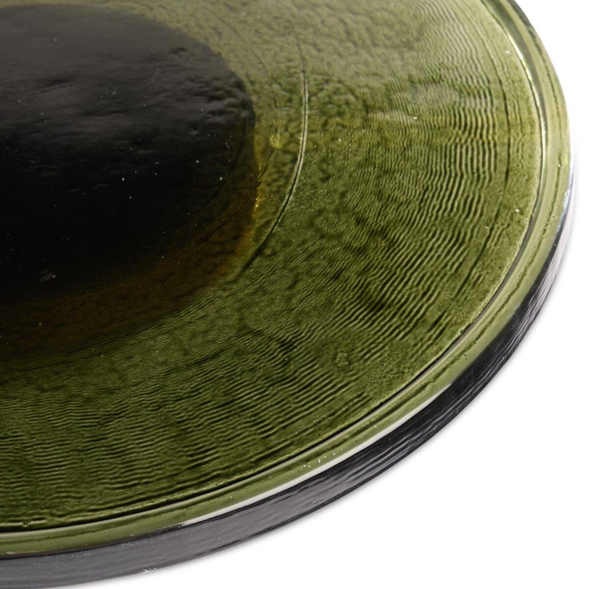 Close-up of the bottom of the Thick Glass Lazy Susan, featuring circular ridges and a concave center, with light reflecting off its food-safe green glass surface.