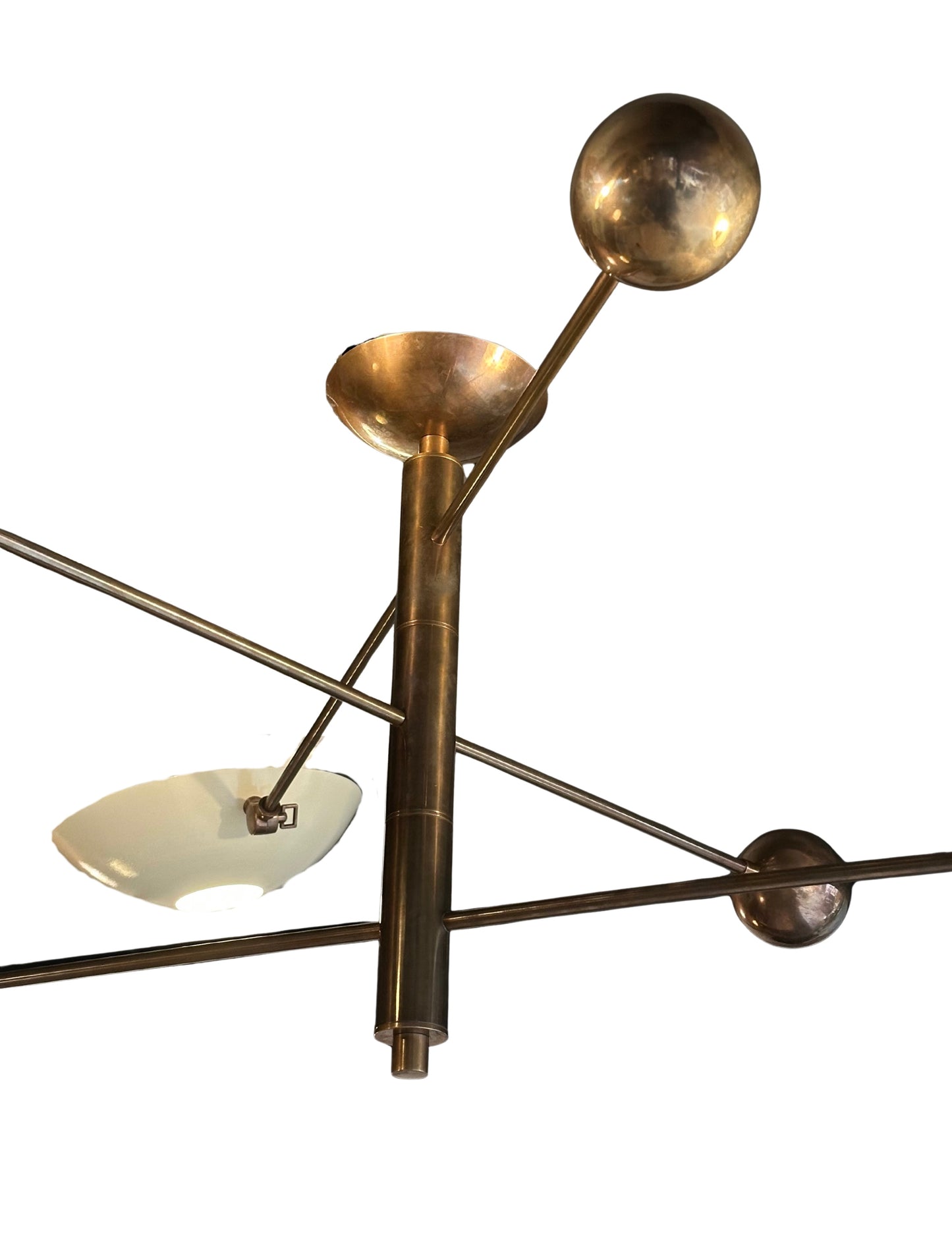 The Mid Century Brass Chandelier features three arms ending in reflective brass spheres, shallow dishes, and white half-spheres, offering a geometric and industrial design ideal for contemporary interiors.