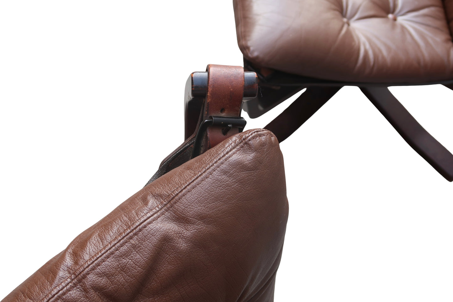 Close-up of vintage Falcon Chairs (Pair) in brown leather, showcasing the cushions and straps connecting the seat and backrest, isolated on a white background.
