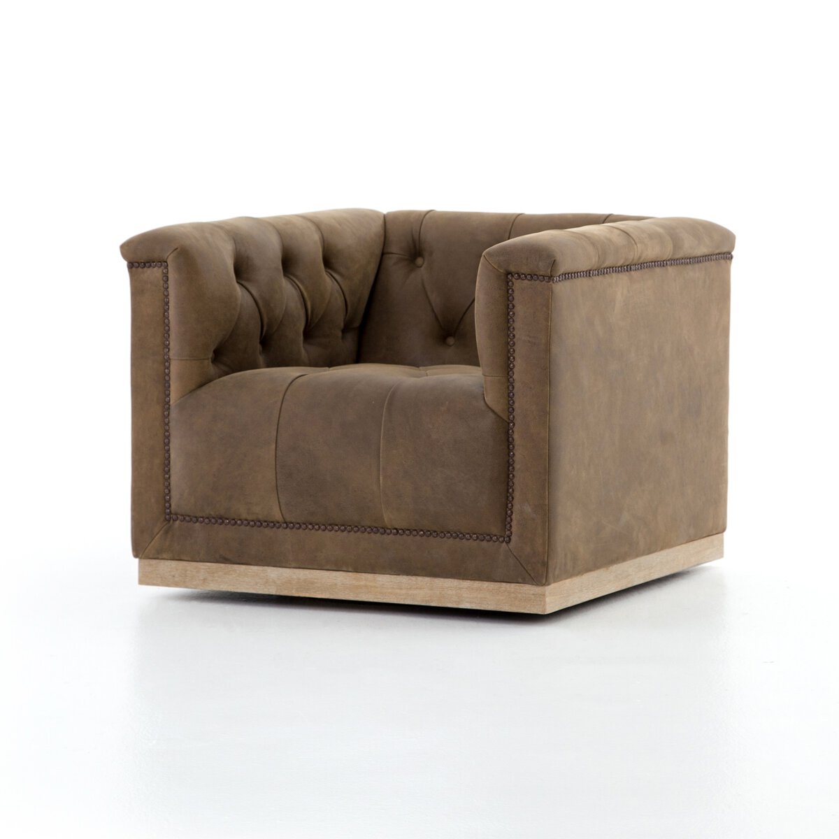 The Leather Library Swivel Chair, a brown tufted leather armchair with boxy sides, nailhead trim, and a low wooden base, measures 33.50"w x 33.75"d x 26.00"h and is shown against a plain white background.