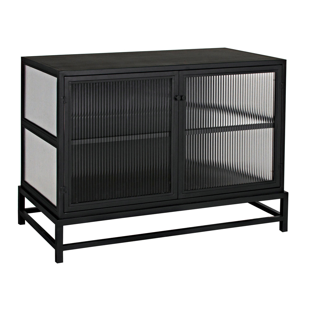 The Chandler 2 Door Sideboard, Black Iron, is a modern industrial cabinet featuring two glass-paneled doors and ribbed glass sides, set on a sleek frame with open storage beneath.