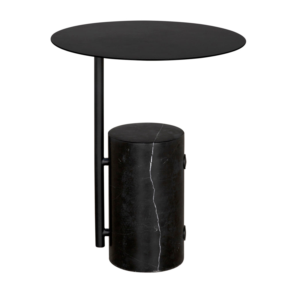 The Juma Side Table features a round, thin black marble top with elegant white veining, supported by a vertical metal rod and a cylindrical marble base—a striking modern accent piece for any space.