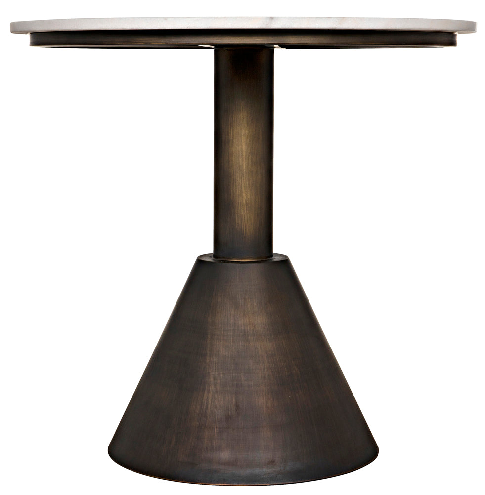 The Joseph Side Table features a round, artisan-crafted design with a white marble top and a single metal pedestal base in aged brass that widens into a cone shape at the bottom.