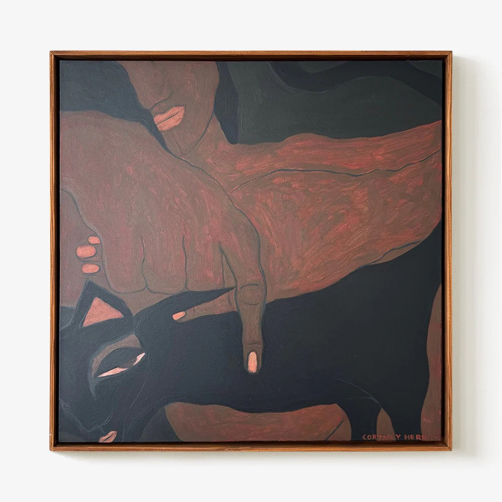 “Quiet Companion” by Courtney Herrot Art depicts a dark-skinned hand resting on a black cat's head, with the person's face partially visible above. The artwork features earthy browns and blacks in a square wooden frame.