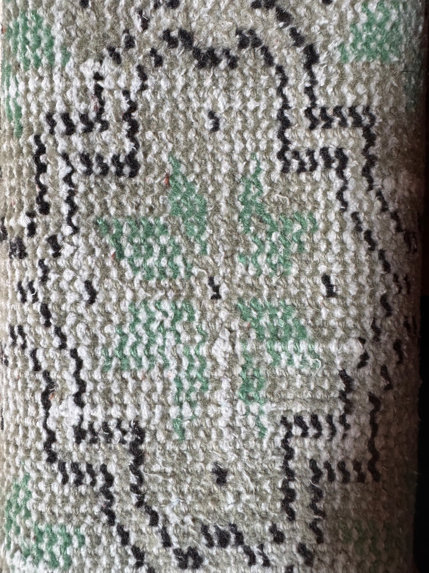 Close-up of the Vintage Turkish Runner Rug featuring a sage geometric pattern in light green, cream, and black. The visible weave and symmetrical shapes make it an ideal 2'5" x 6' green hallway accent.