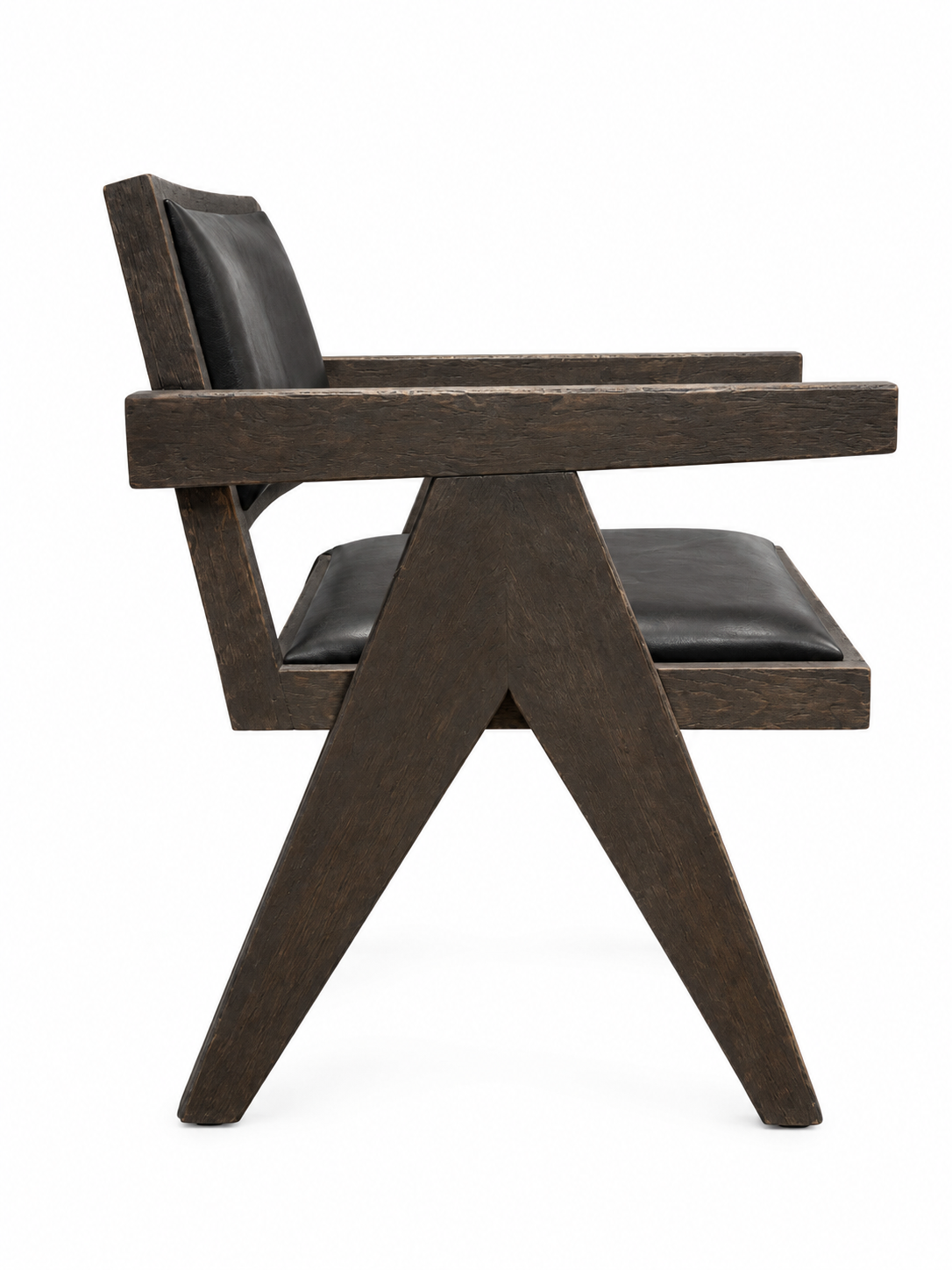 A side view of the V-Leg Wood & Leather Armchair: dark wood, geometric angular frame, black leather seat (23.25″D) and backrest, 22.75″W x 29.5″H, shown against a white background.