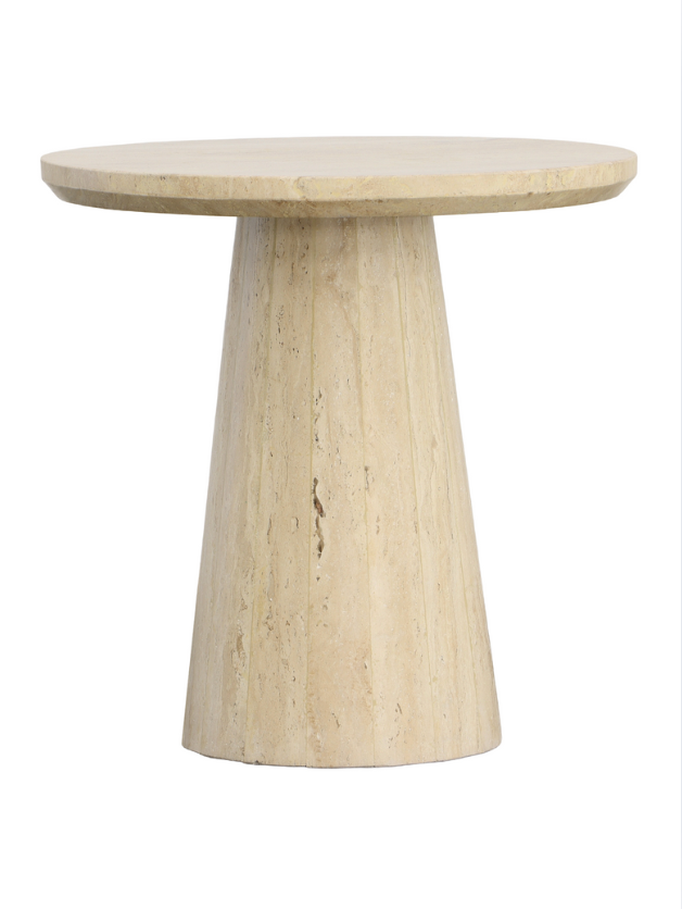 The Travertine Pedestal Side Table features a round travertine stone top and a wide, tapered cylindrical base, shown against a white background.