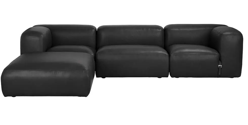The Modular Black Leather Belted Sofa features rounded cushioned arms and a left-side chaise lounge, available in multiple configurations to fit your space, shown here against a plain white background.