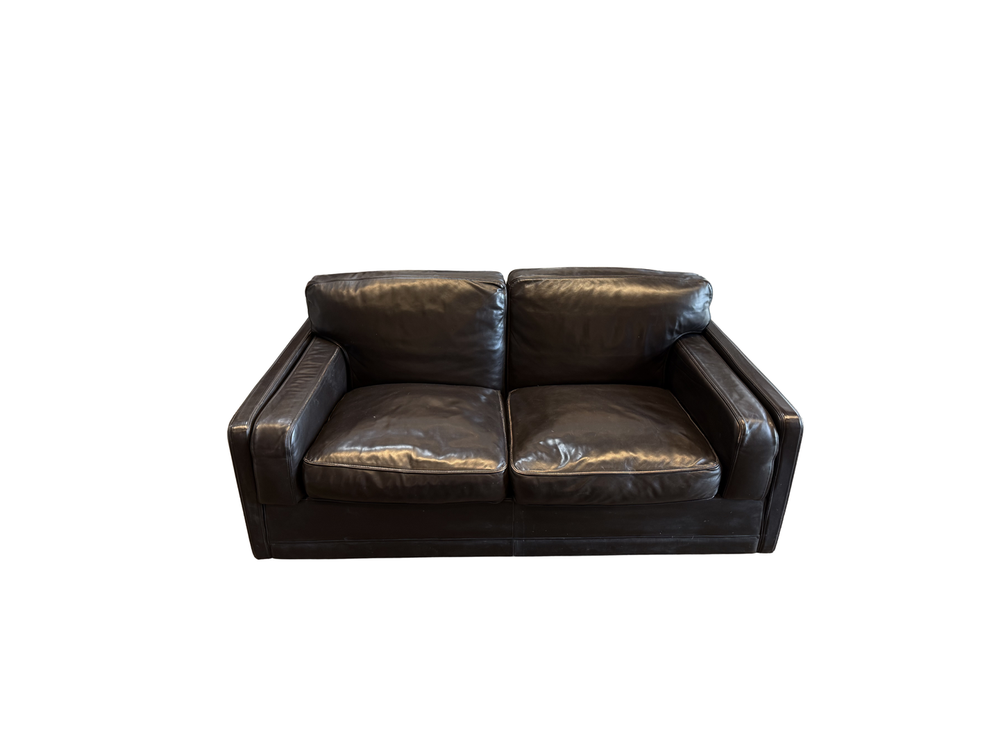 The Vintage Italian Black Leather LoveSeat, featuring wide armrests and two seat cushions, offers chic style for any space—ideal beside a modern bathtub in your contemporary home.