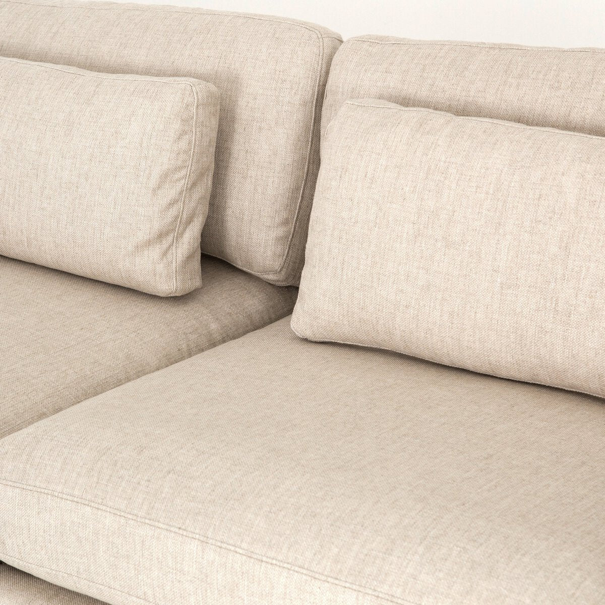 Close-up of the 3-pc Modern Low Sectional in beige fabric, featuring two large back cushions and two rectangular bolsters, highlighting the textured upholstery and detailed stitching.