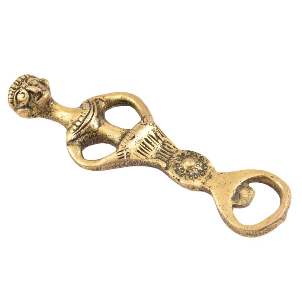 The Tribal Brass Bottle Opener is shaped like a human figure with detailed facial features, arms on hips, and decorative patterns. Its compact 13 cm x 3.8 cm x 0.4 cm size makes it stylish and easy to use.