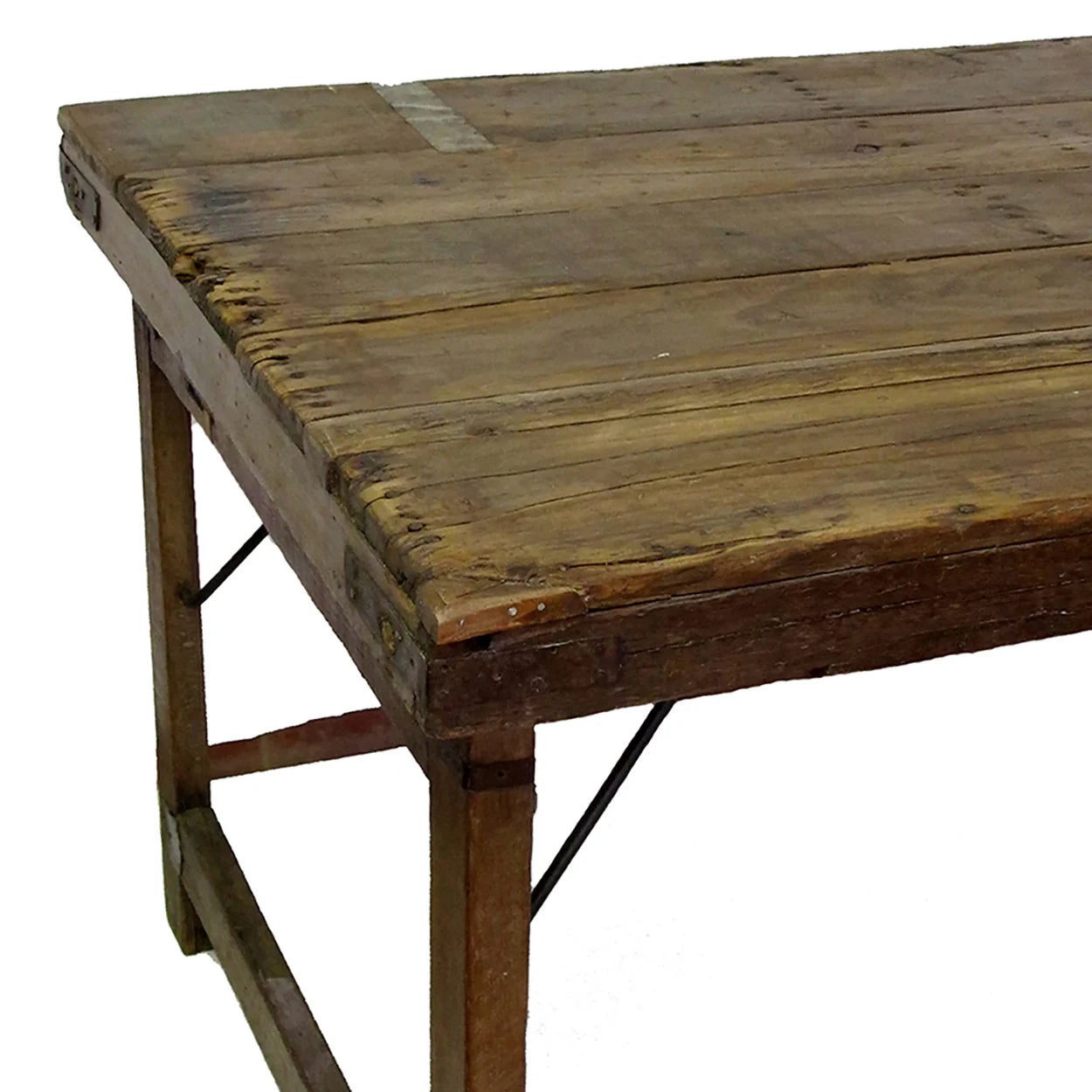 The Indian Wedding Dining Table features a weathered, rustic finish with visible scratches and worn edges, supported by simple legs and metal braces—ideal for anyone seeking a unique handcrafted table for special occasions.