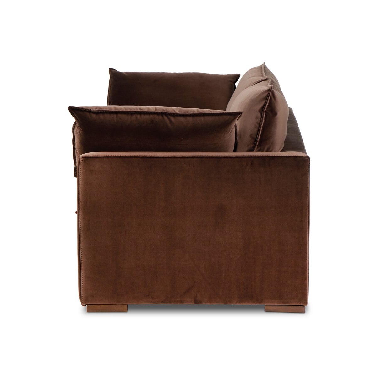 Side view of the "Sunken" Sofa in brown velvet upholstery with large, plush feather-blend cushions and a boxy, modern design, displayed against a white background.