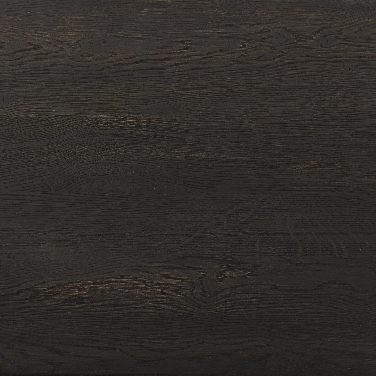 The Primitive Nightstand features a dark brown textured wood surface with visible grain patterns and subtle natural lines, showcasing a cocoa-finished oak that highlights organic carving details.