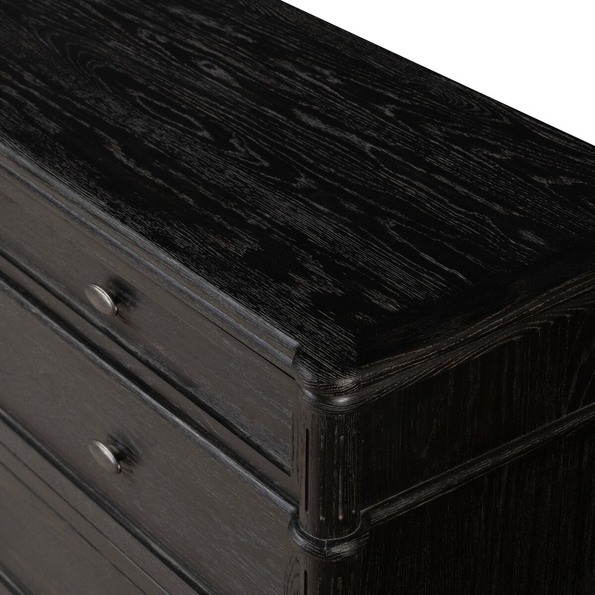 Close-up of the European 9 Drawer Dresser in toasted oak, showing the top and upper drawers with a smooth, textured surface, round metal knobs, gently rounded front corners, and visible wood grain for a modern look.