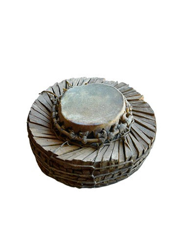 The Vintage Tribal Drum is a rare, traditional wooden drum with a round, flat top and intricate crisscrossed lacing along the sides, displayed on a white background.