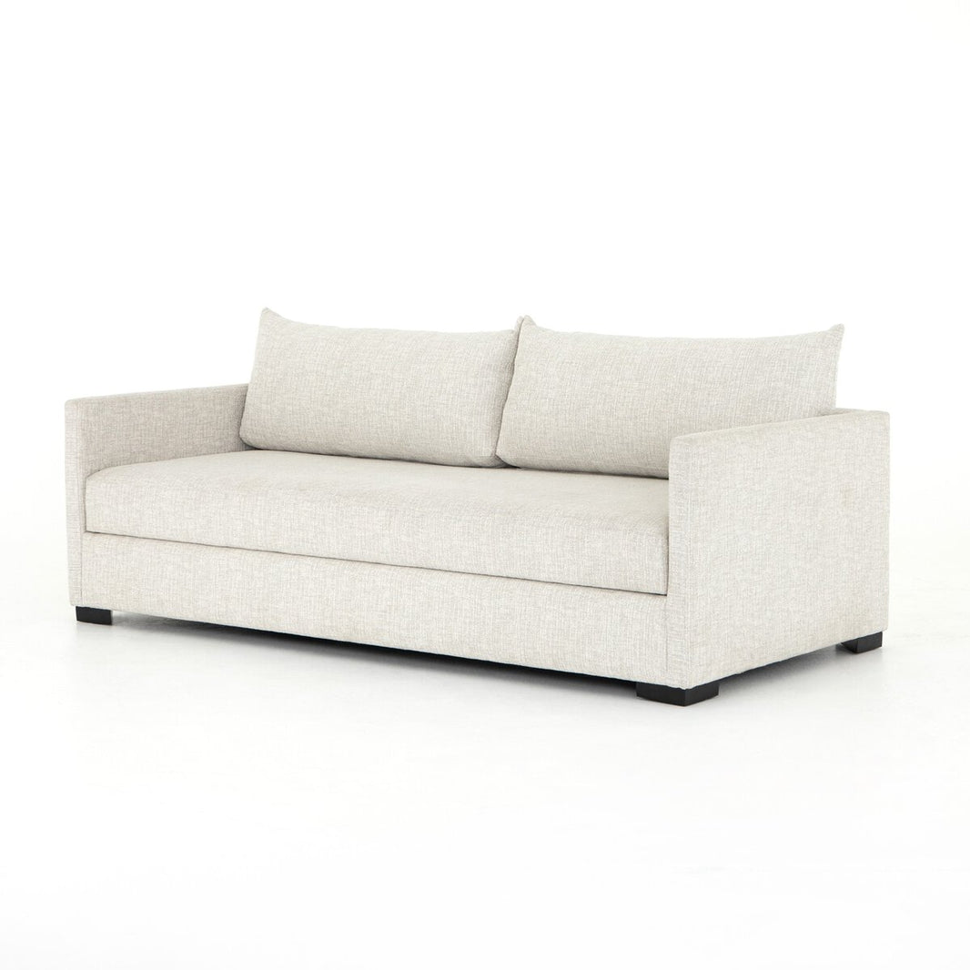 The Wickham Sleeper Sofa features modern, light beige upholstery, clean lines, rectangular arms, and two large back cushions—perfect for complementing queen or full bed dimensions in any stylish space.