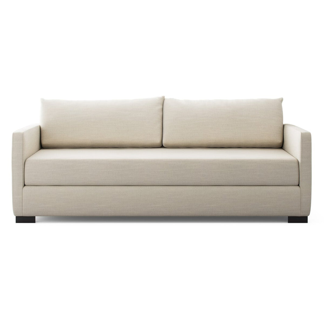 The Classic Sofa Bed, with a modern boxy design, light beige upholstery, straight armrests, two back cushions, and short black legs, is shown from the front against a white background.