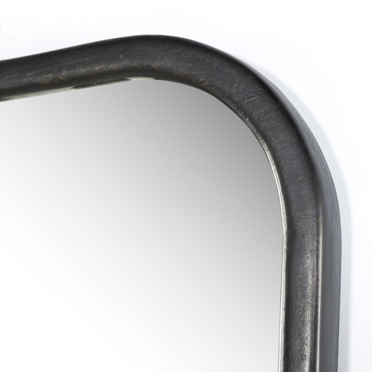 Close-up of the upper corner of the Patz Mantel Mirror, featuring a thick, dark metal frame with rounded edges. Shown against a plain white background. Overall dimensions: 40.00"w x 1.75"d x 33.00"h.