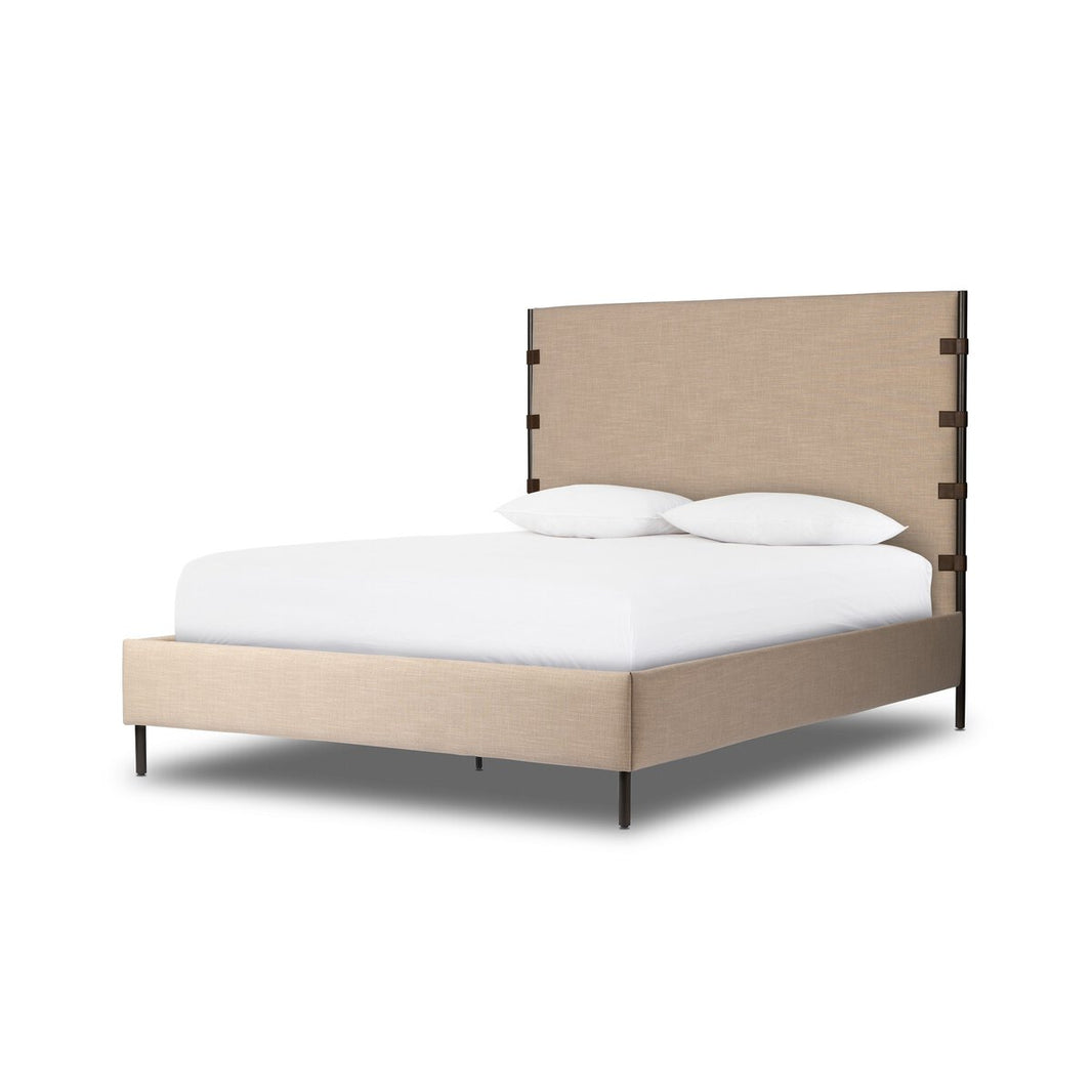 The High-Backed Queen Bed - Beige features a tall, rectangular headboard with black accents on the sides and slim black legs. Built with a sturdy metal bed frame for enhanced durability, the bed is styled with white linens and two pillows, displayed against a white background.