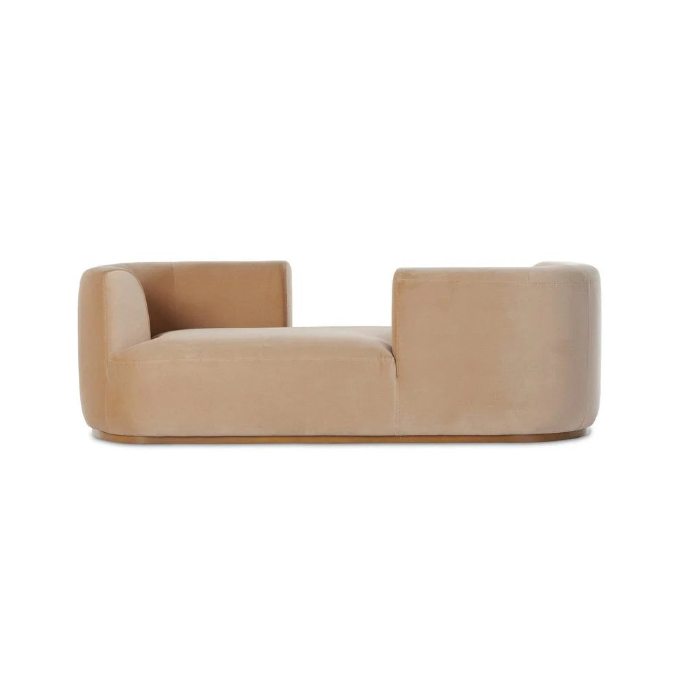 The Deandra Tete A Tete Chaise is a modern, beige velvet 90.5" sofa with a low backrest, armrests at both ends, and a distinctive open right-side design.