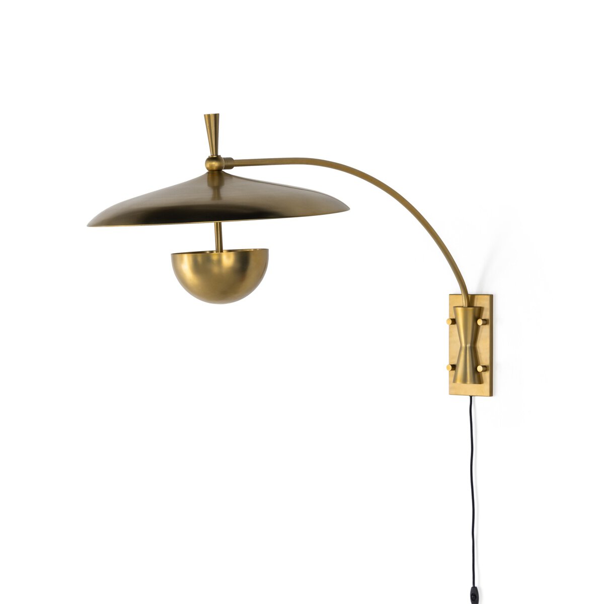 The Mid Century Brass Iron Sconce features a brass wall mount, curved arm, dome shade, half-sphere bulb cover, and rectangular plate with decorative bolts. A black cord hangs from the base. Check product measurements for best fit with your furniture.