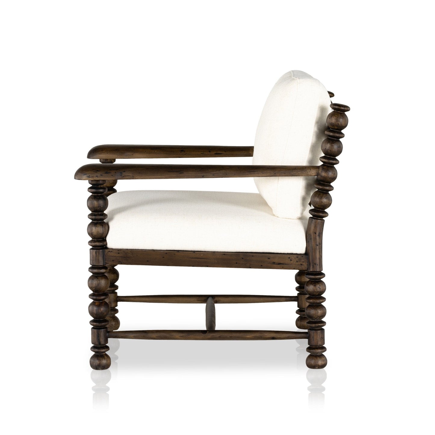 Side view of the Davies Chair, a wooden armchair with rounded spindle-style legs and arms, upholstered in white fabric on the seat and backrest. Overall dimensions: 28.50"w x 32.00"d x 33.00"h, shown against a plain white background.