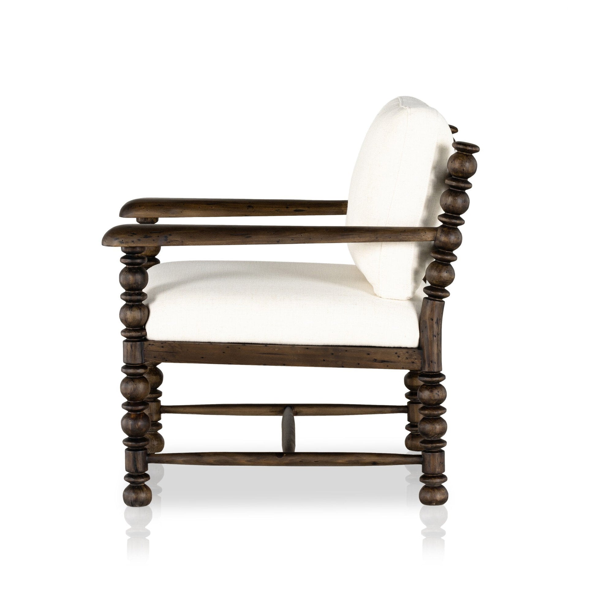 Side view of the Davies Chair, a wooden armchair with rounded spindle-style legs and arms, upholstered in white fabric on the seat and backrest. Overall dimensions: 28.50"w x 32.00"d x 33.00"h, shown against a plain white background.