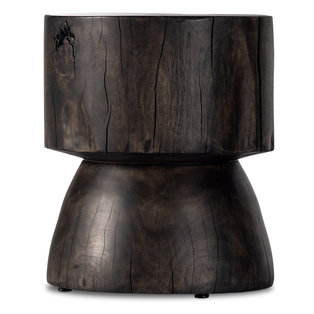 The Organic Trunk End Table is hand-carved from reclaimed wood, featuring a dark finish, cylindrical top, and wider rounded base. Natural cracks and a smooth rustic surface accentuate its organic aesthetic.