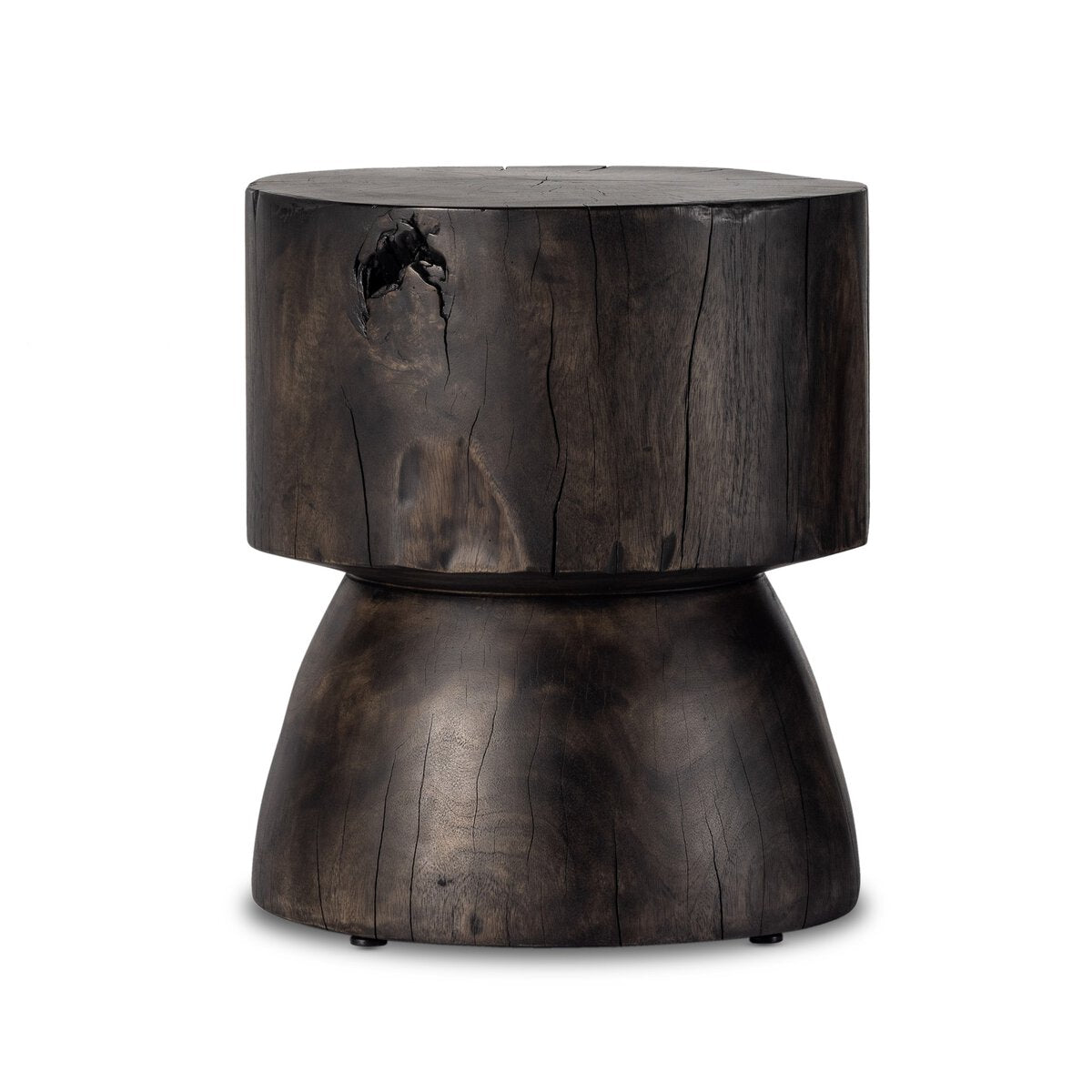 The Organic Trunk End Table is a dark, rustic stool with a cylindrical top and rounded, flared base, hand-carved from reclaimed wood and showcasing natural cracks and rich grain for an authentic, organic look.