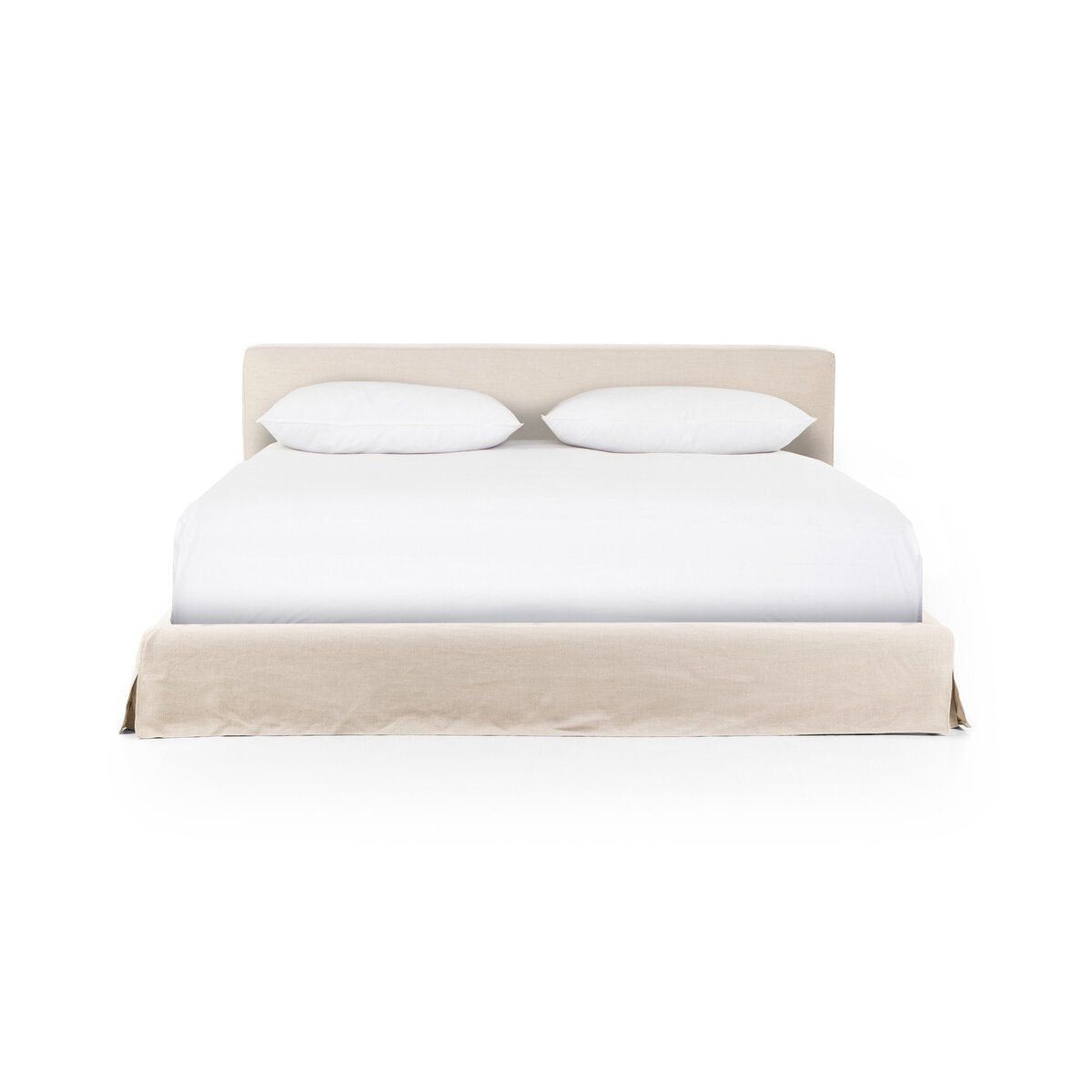 The Aidan Slipcover Bed, a beige upholstered King bed with a low headboard, is shown against a white background and styled with white bedding and pillows. Its overall dimensions are designed for spacious comfort.