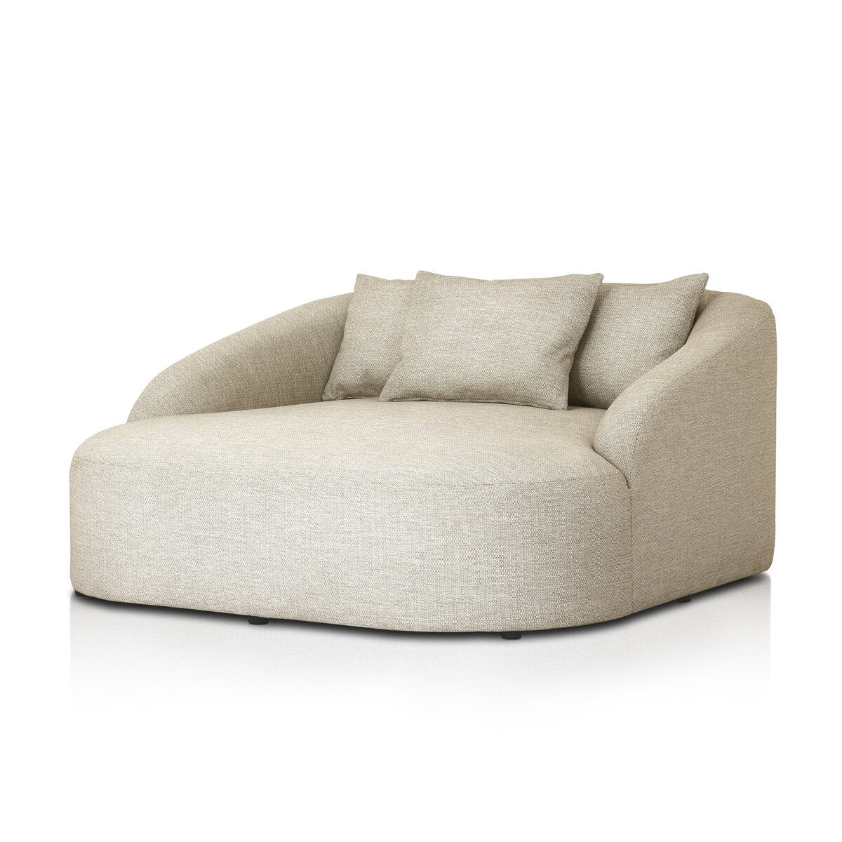 The Outdoor Day Bed is a modern, oversized sand beige lounge chair with curved edges, low arms, soft upholstery, and two matching cushions—ideal for relaxing in style outside.