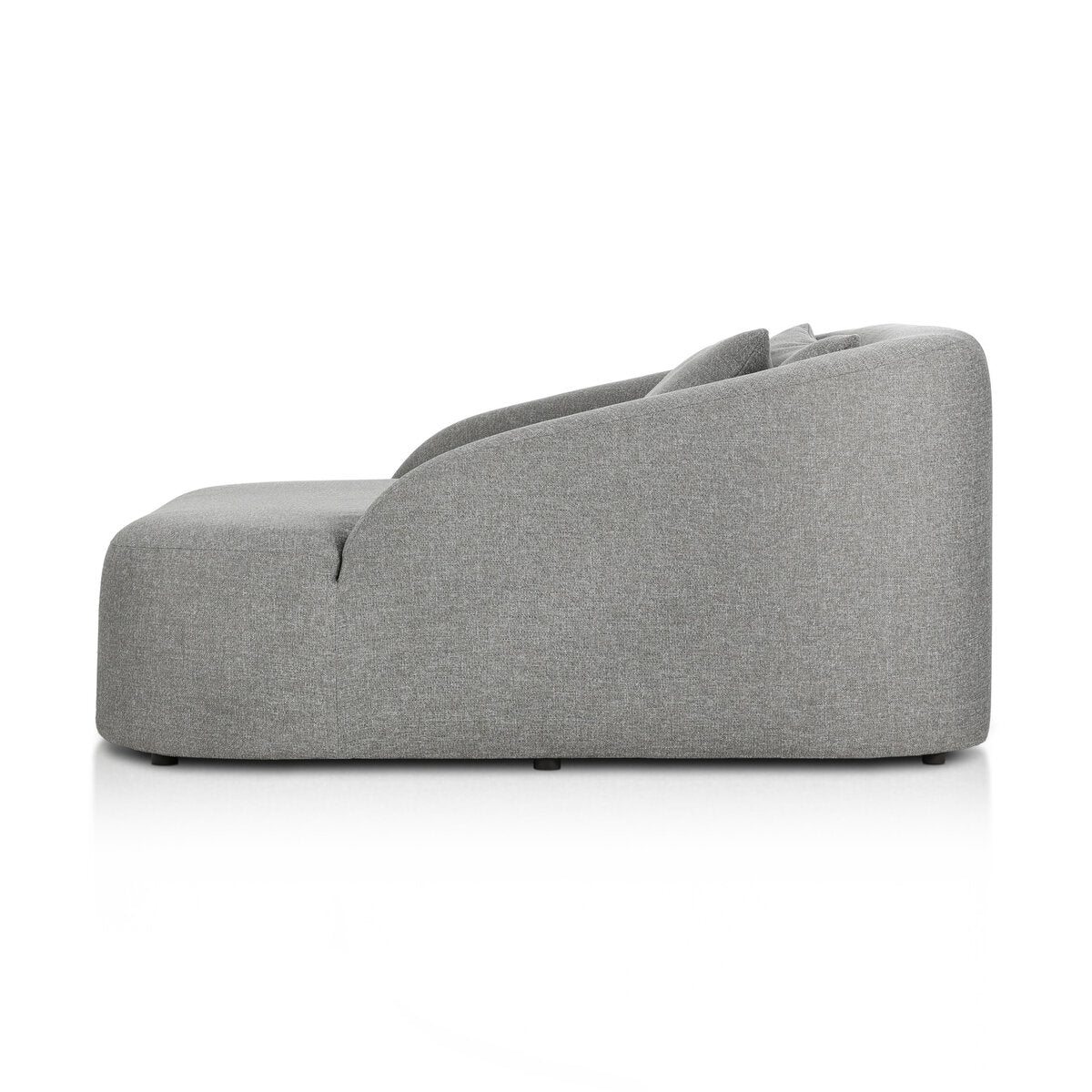Side view of the Outdoor Day Bed, a modern light gray upholstered sofa featuring a curved backrest and smooth, rounded edges, shown on a white background.