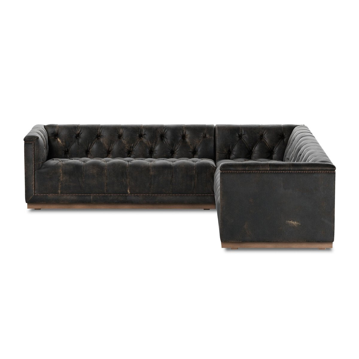 The Maxx 3-Piece Sectional is a spacious, L-shaped black leather sofa with tufted back and seat cushions, accented by nailhead trim—an elegant addition to any living room.