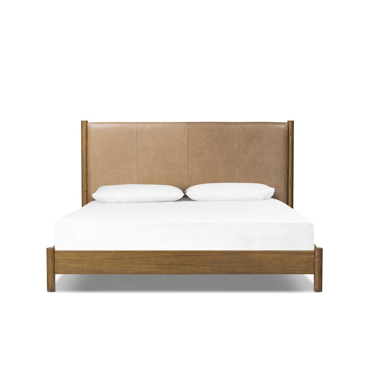 The Roark Bed is a wooden king bed frame with a tan upholstered headboard, shown with a white mattress and two pillows on a plain white background. Its generous dimensions provide a spacious and comfortable sleep experience.