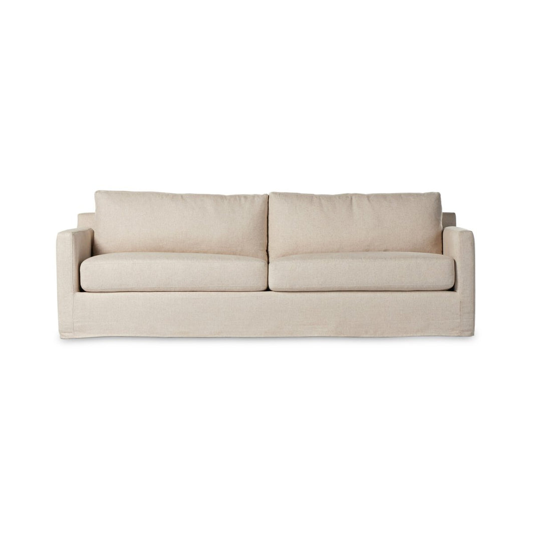 The Hampton Slipcover Sofa, a modern beige design with two seat and back cushions plus straight arms, is displayed against a white background—ideal for anyone focused on sofa dimensions and furniture size.