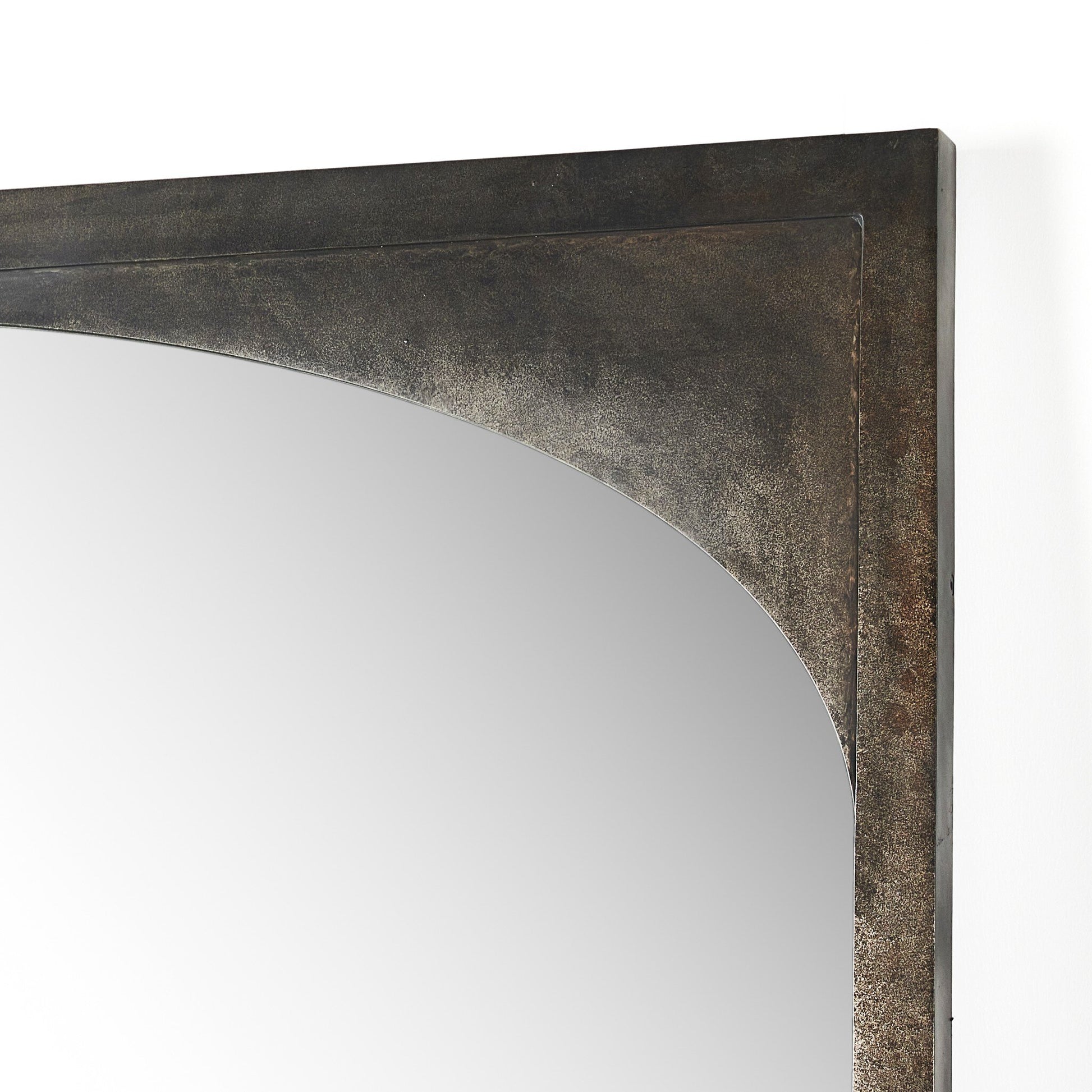 Close-up of the top right corner of the Troyes Floor Mirror, featuring a burnished charcoal metal frame with a gentle inward curve and smooth reflective surface. Overall dimensions: 60x2x79.5 cm. Set against a white background.