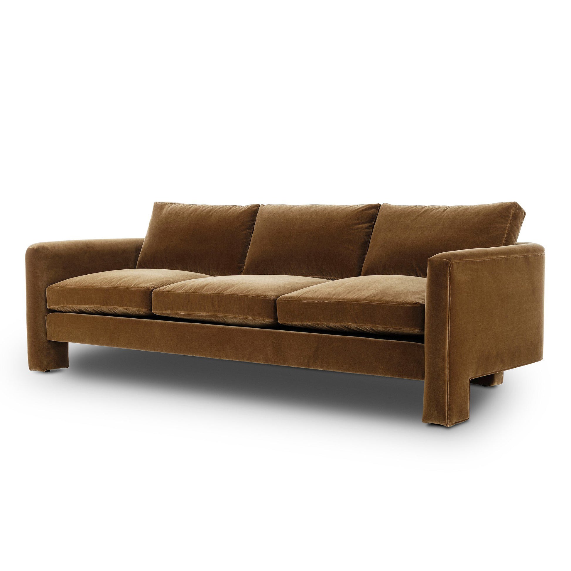 The Katya Sofa is a modern brown velvet piece with three seat and back cushions, wide squared armrests, and a minimalist design. See product dimensions for detailed measurements.