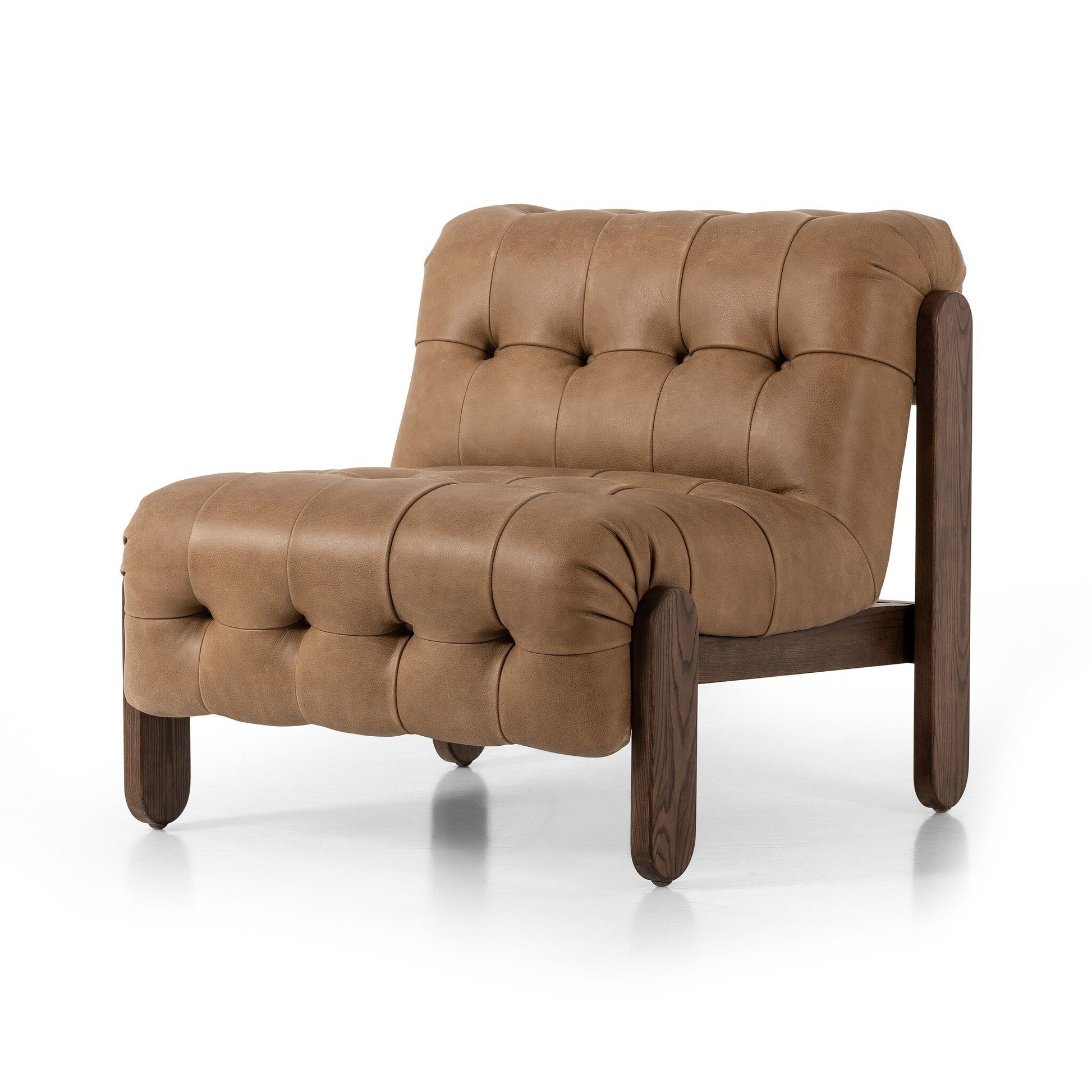 The Jeremiah Chair features tufted light brown leather upholstery, a dark wooden frame, low seat, and plush rounded cushioning. Measuring 35.5"D x 30"W, it’s a stylish addition to any contemporary space.