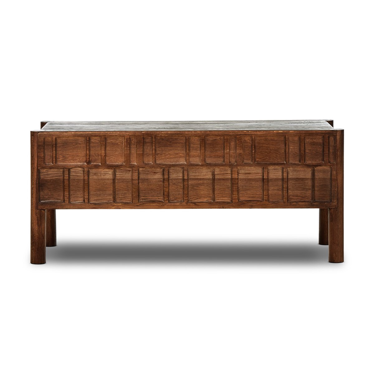 The Carved Geometric Desk features a rectangular wooden design with a carved geometric front panel and four straight legs—perfect beside a solid oak desk or as a statement piece in any modern space.