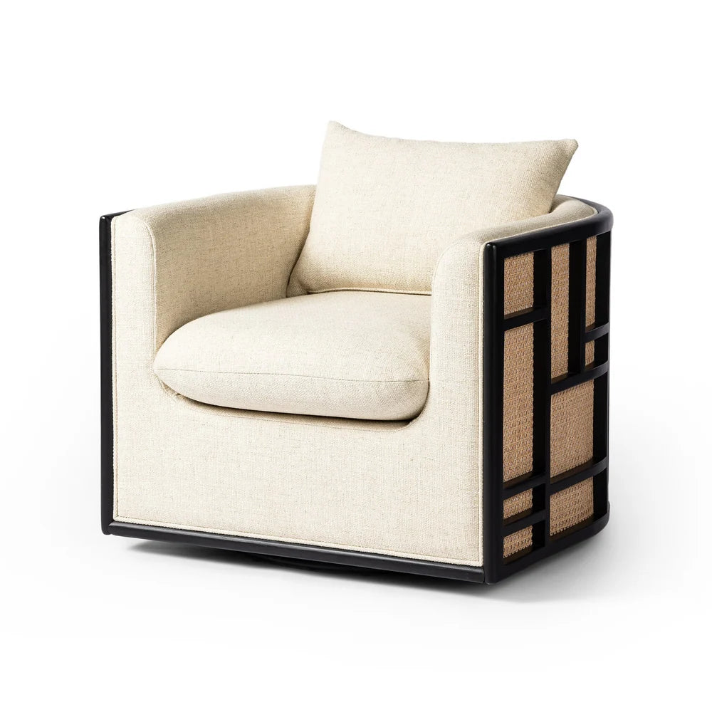 June Swivel Chair in cream-colored, high-performance fabric with a black geometric parawood frame and woven cane side panels.