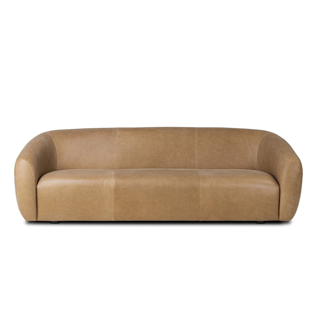 The Rounded 100" Sofa is a modern, tan leather piece with rounded arms and a low back, offering a smooth, minimalist look—ideal for anyone considering sofa dimensions and precise furniture measurements.