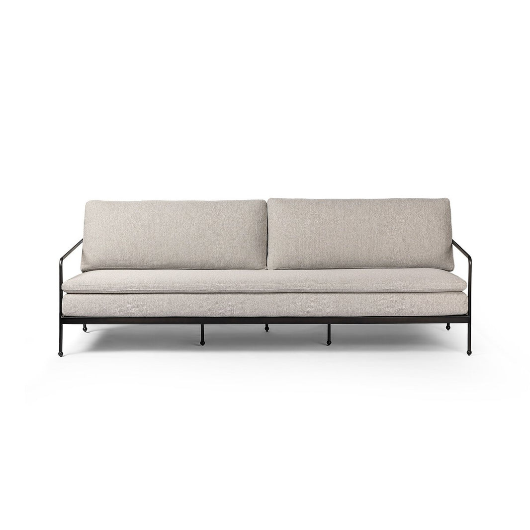 The Tally Outdoor Sofa features light grey cushions and a slim black metal frame, offering modern, minimalist style and ideal dimensions—perfect for those seeking stylish seating. Displayed against a white background.