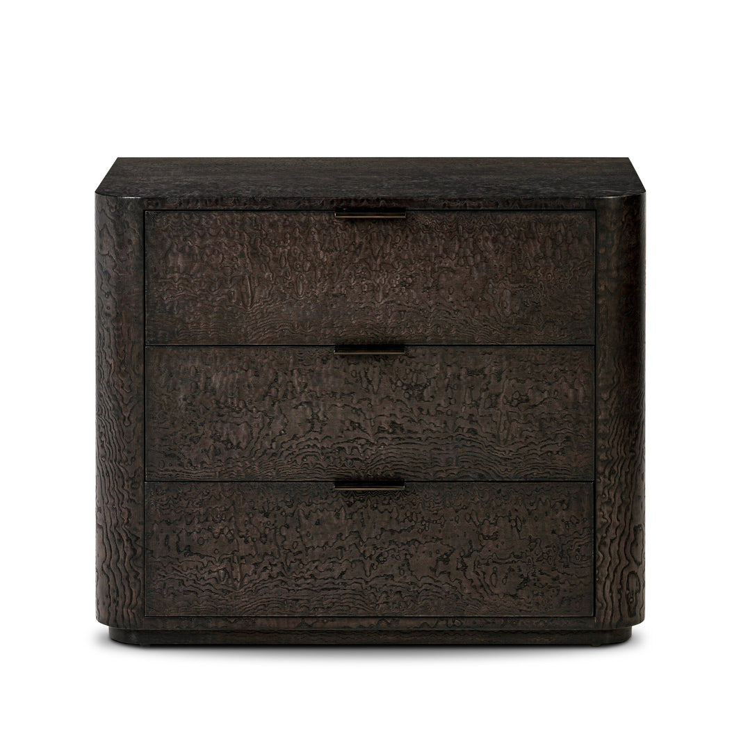 The Stenson 3 Drawer Nightstand features dark wood, three drawers with rectangular pulls, textured wavy grain, and softly rounded corners. Its modern design measures 32"w x 20"d x 26.5"h, perfect for contemporary spaces.
