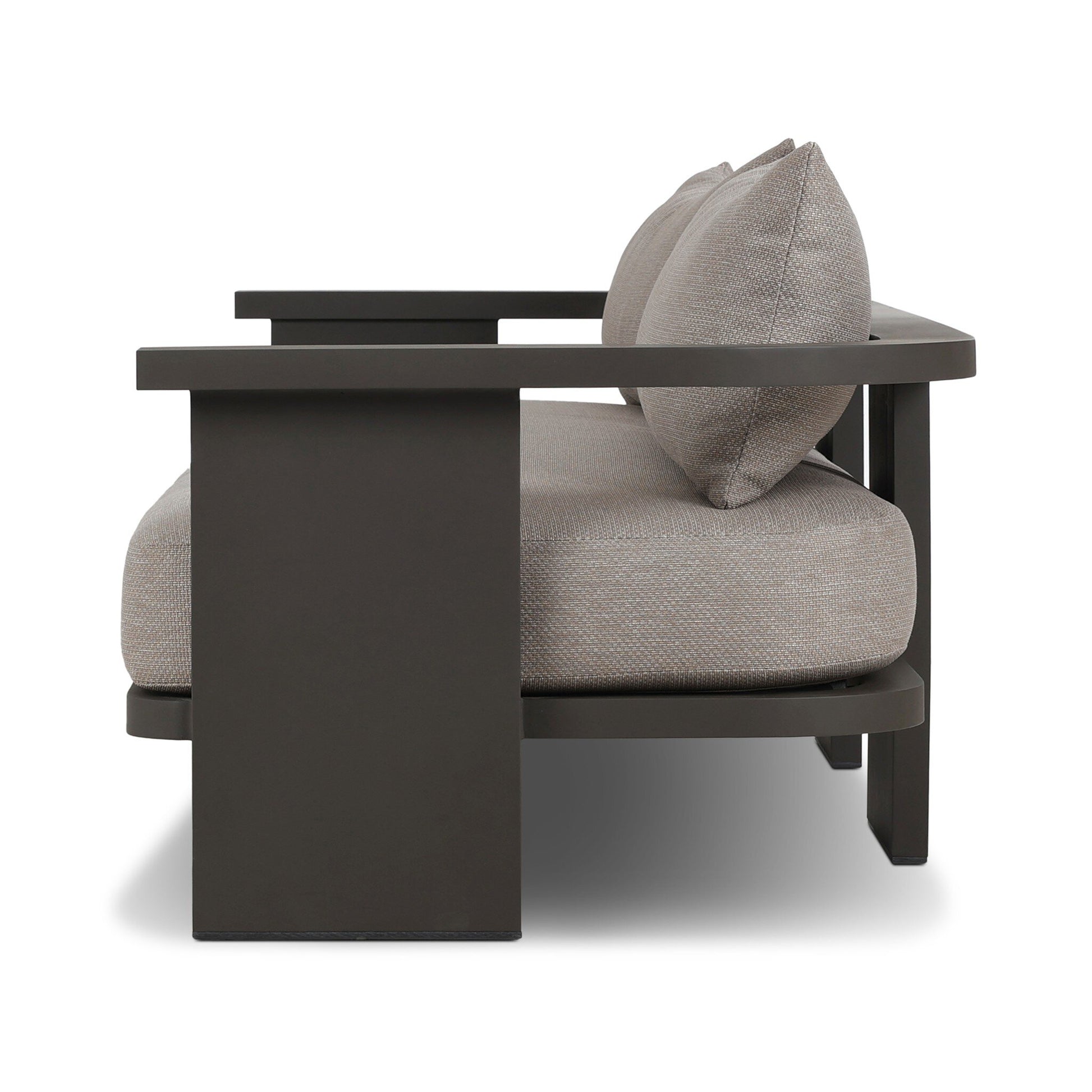 Side view of the Aluminum Wide-Frame Outdoor Sofa featuring a dark, angular aluminum frame and light beige high-performance fabric cushions with two back pillows, shown against a white background.