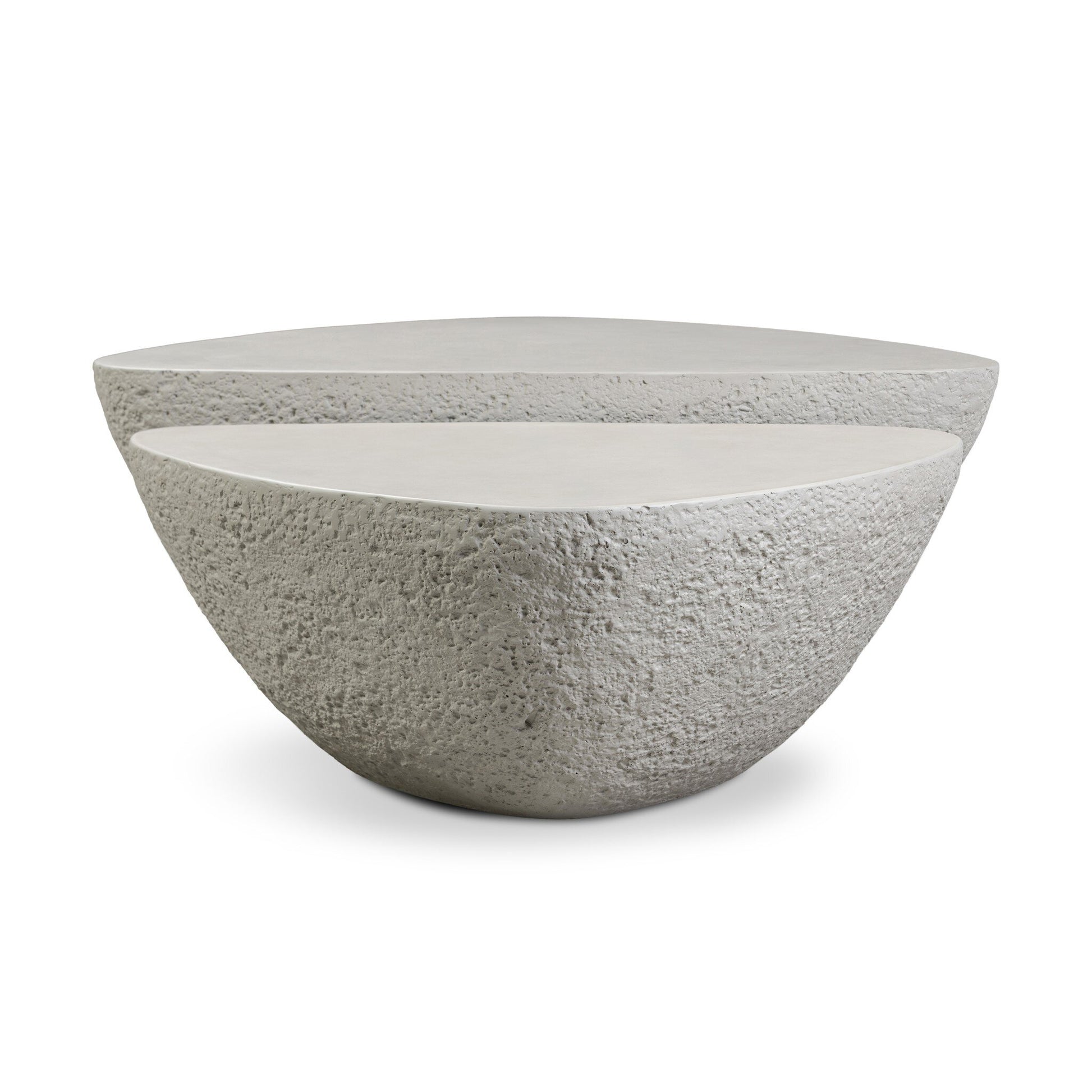 The Concrete Organic Nesting Outdoor Coffee Tables feature two modern, irregularly shaped pieces in light gray stone with smooth tops and textured sides, creating a minimalist, sculptural focal point for any outdoor space.
