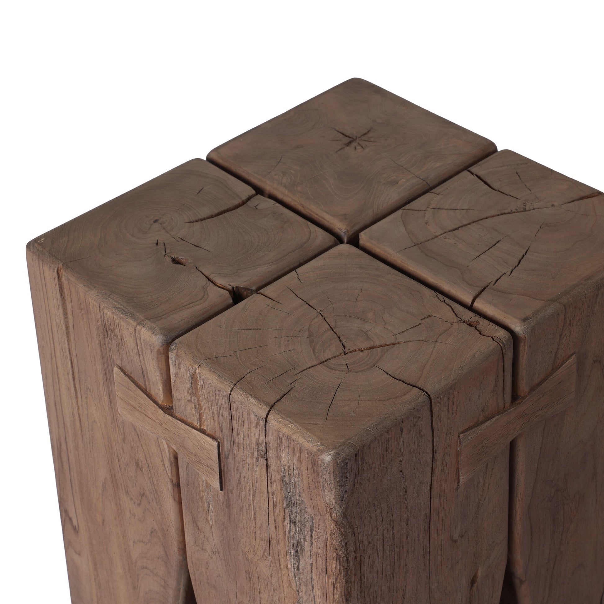 A close-up of the Solid Teak Tiered Pillar Outdoor End Table, crafted from solid teak blocks with natural cracks, unique grain patterns, and detailed joinery, showcasing its rustic, pillar-style design.