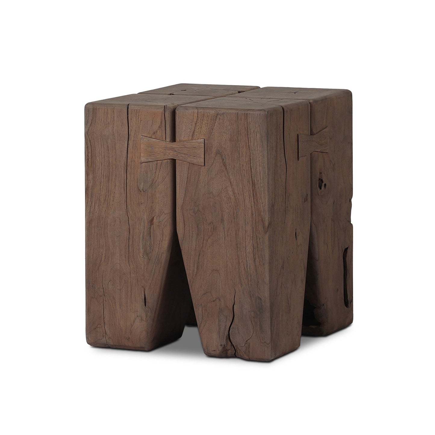 The Solid Teak Tiered Pillar Outdoor End Table is crafted from thick, rectangular solid teak blocks with visible grain, knots, and cracks, and includes a butterfly joint detail near the top.