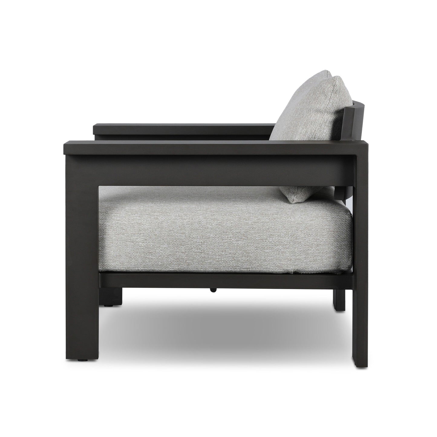 Side view of the Aluminum Angular Accent Outdoor Chair by Canyon Creative Studio, featuring a matte black aluminum frame and light gray cushions, shown against a white background; overall dimensions available upon request.